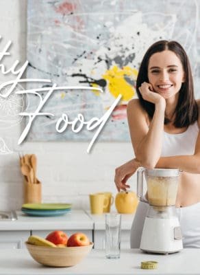 Slim sportswoman smiling at camera while preparing smoothie near measuring tape on kitchen table and healthy food illustration