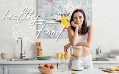 Slim sportswoman smiling at camera while preparing smoothie near measuring tape on kitchen table and healthy food illustration