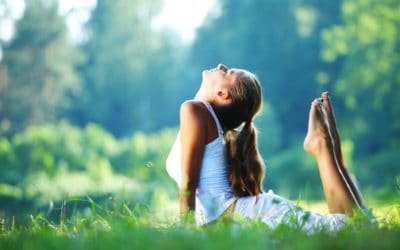 10 Yoga Practices for Healthy Aging 30 Yoga woman in white on green park grass in cobra asana pose